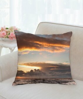 garden cushion with setting sun at sea with clouds
